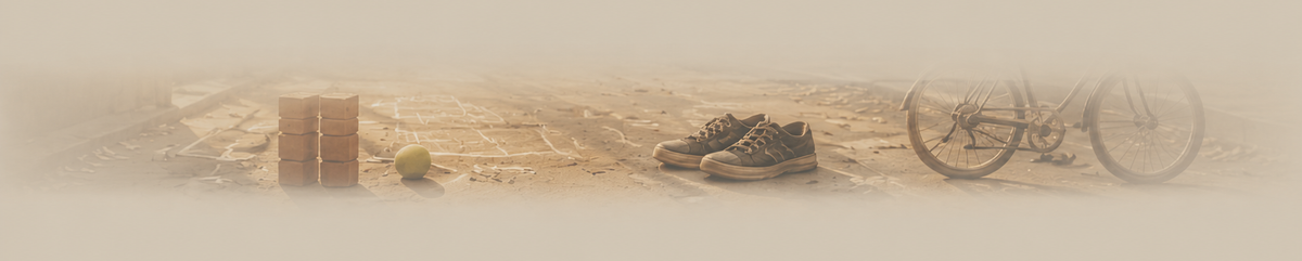 A faded, low-contrast horizontal banner-style scene showing a pair of dark sneakers, a bicycle wheel, a small green ball, and a brown box on a sandy ground.